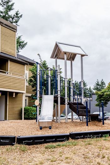 a playground with a swing set and a slide